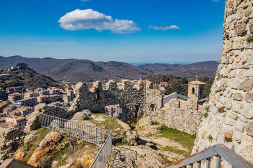 The small village of Tolfa, in Lazio. The remains of the ancient walls of the fortress that stands on top of the cliff. The ruins of the castle and the houses of the town located downstream.
